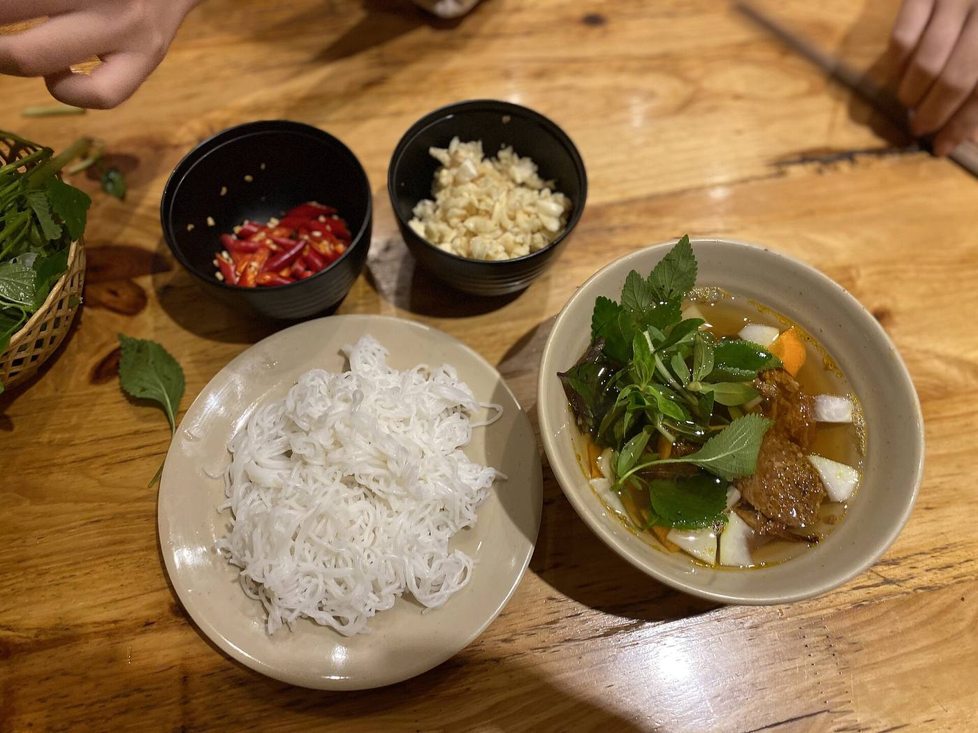ブンチャー。炭火で焼いた豚肉のつけ汁に、米の麺と香草を浸して食べる